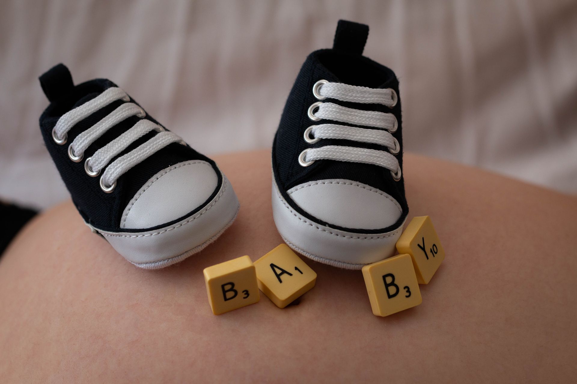 Chaussures bébé posées sur le ventre de maman - Esther Raguenet Photographie 
